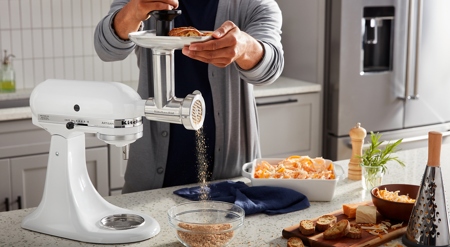 Person using KitchenAid® stand mixer to grind bread