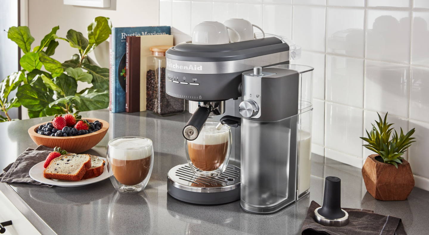 Espresso machine and lattes on countertop with breakfast items