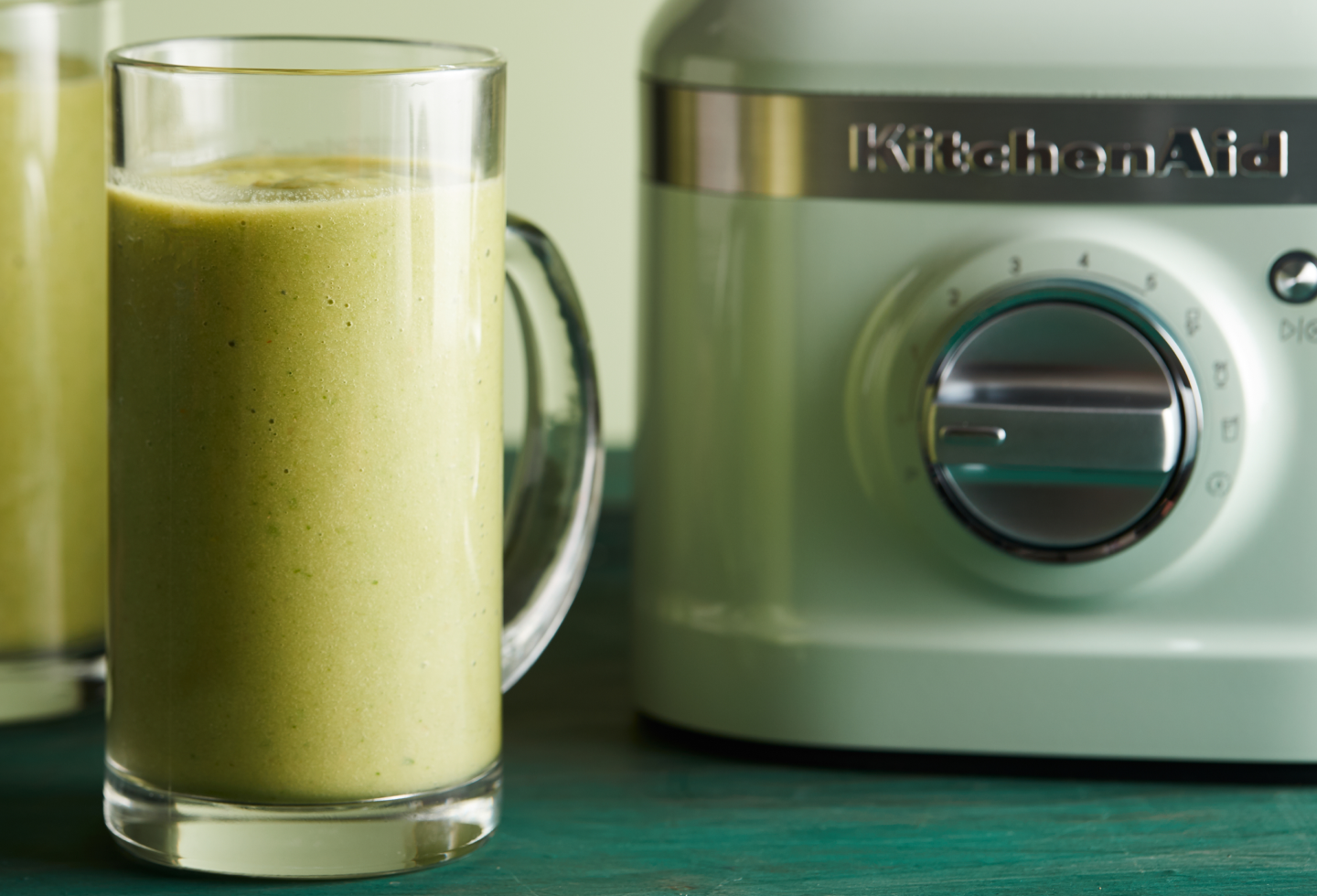 Pineapple juice next to a KitchenAid® blender
