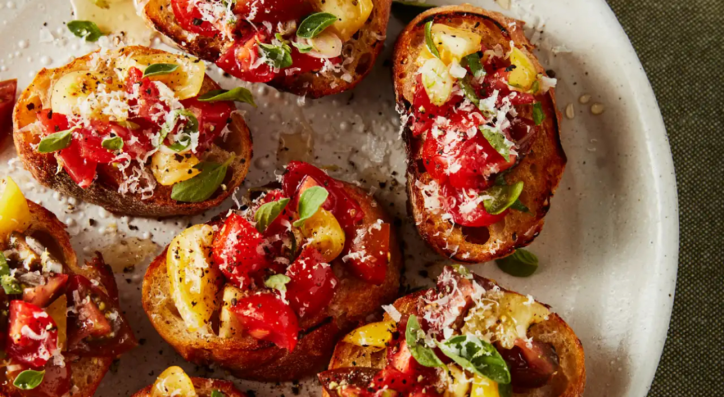 Fresh bruschetta garnished with basil.