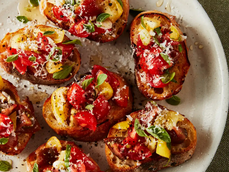 Fresh bruschetta garnished with basil.