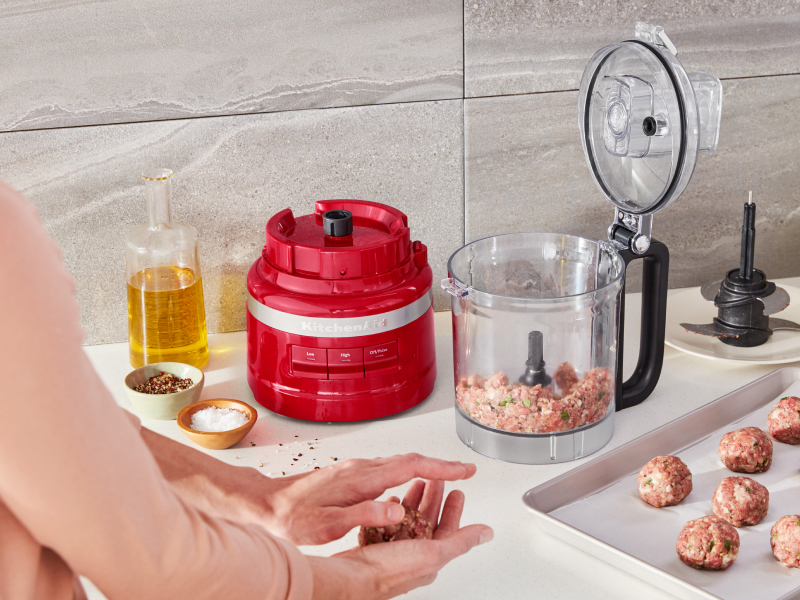 Ground beef inside a red KitchenAid® food processor
