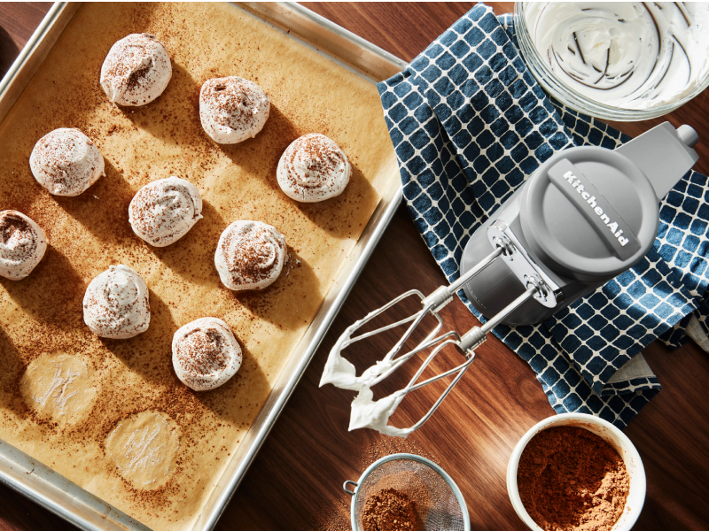 KitchenAid® hand mixer and meringue on a cookie sheet