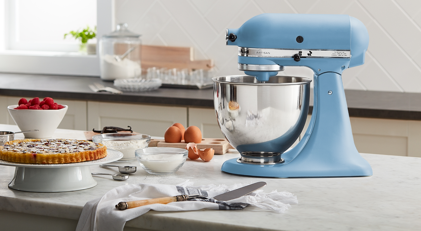 A light blue KitchenAid® stand mixer next to various ingredients
