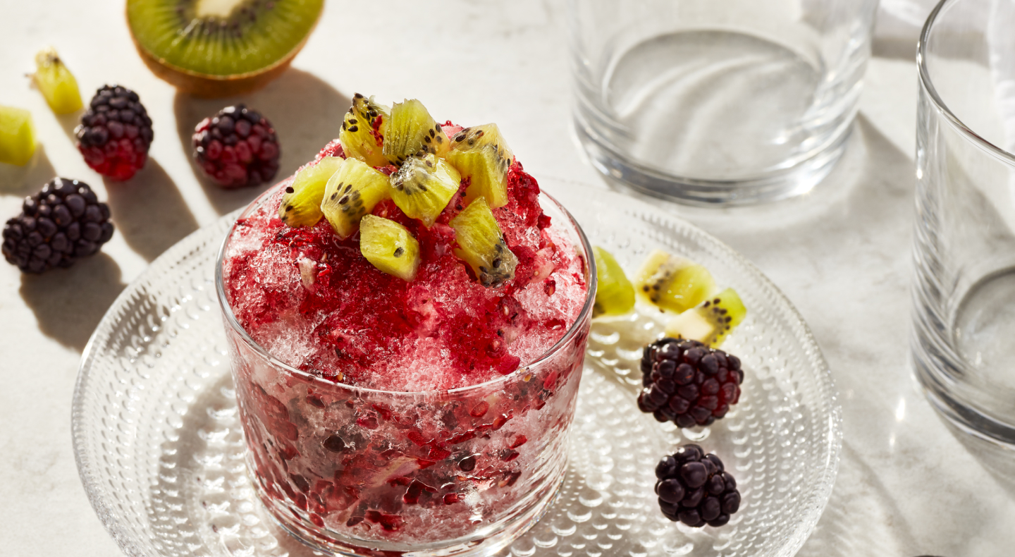 Shaved ice dessert topped with chopped fruit 