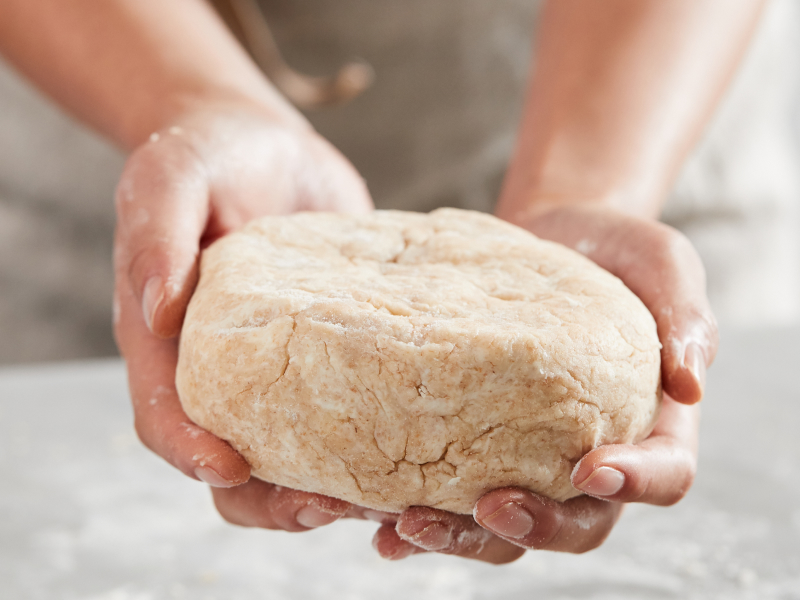 Kneaded dough in a person's hands
