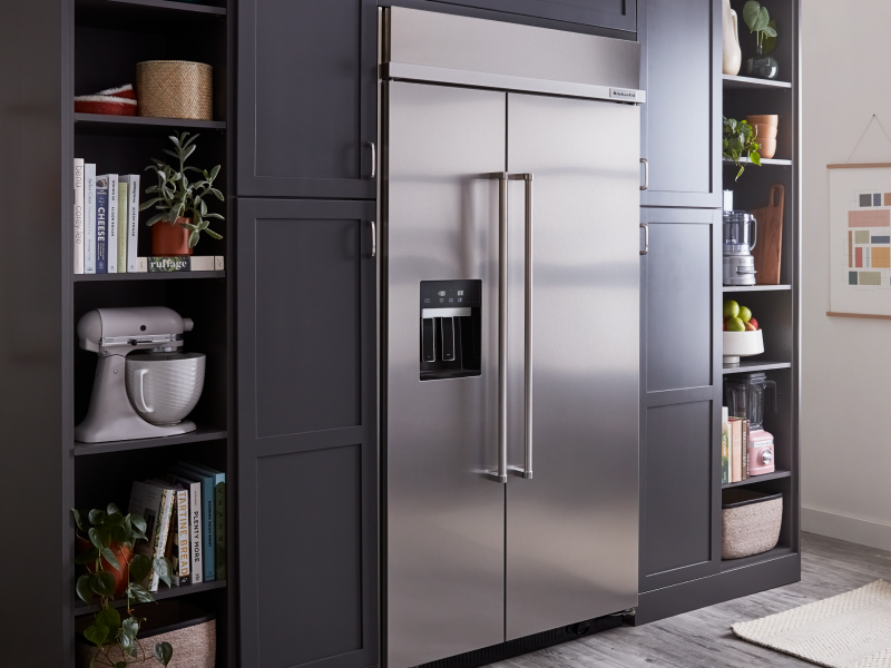 A stainless steel KitchenAid® side-by-side fridge in a kitchen