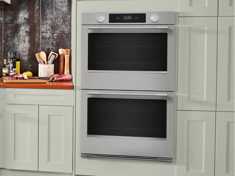 A double wall oven surrounded by cabinetry