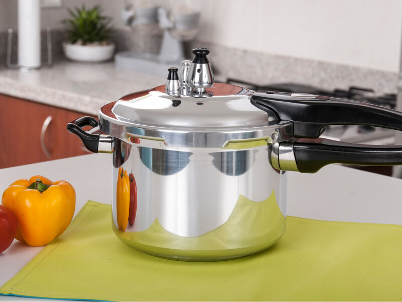 A shiny, metal pressure cooker
