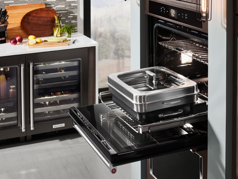 An oven with cookware used for steaming