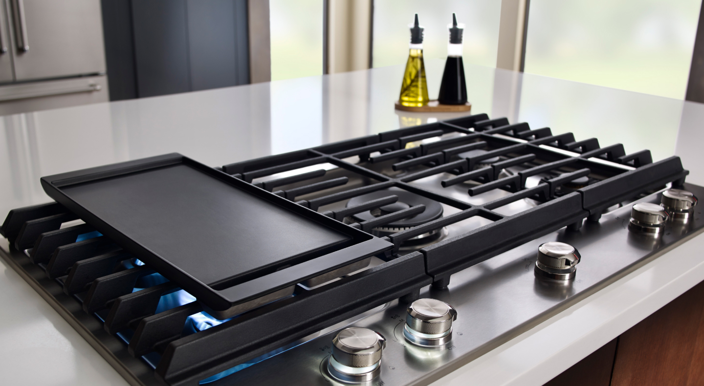A griddle preheating on a gas stove