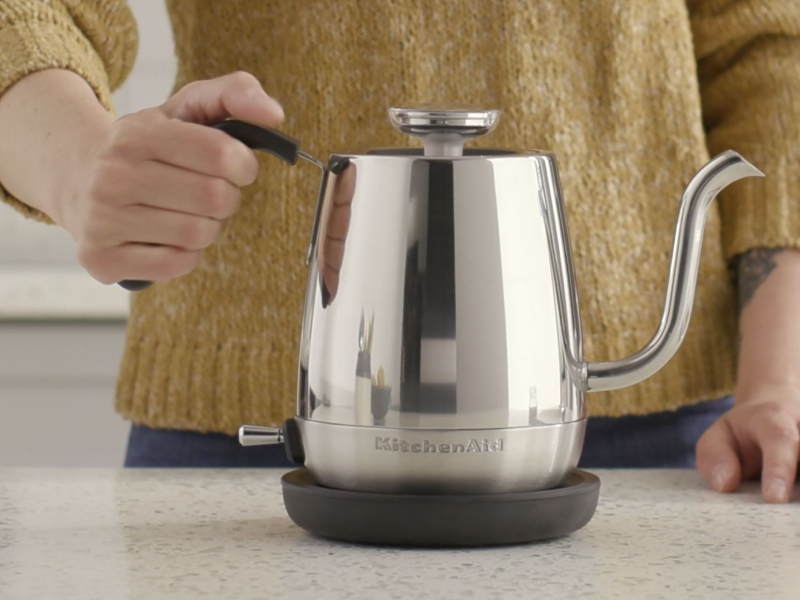 Maker setting stainless steel KitchenAid® electric kettle on countertop