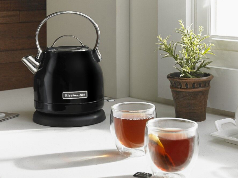 KitchenAid® kettle on countertop with three cups of tea