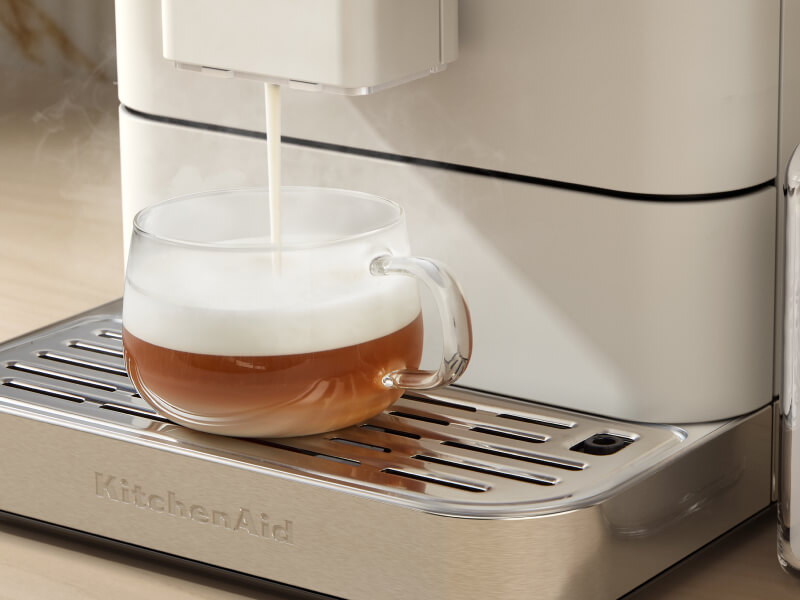 Frothed milk being poured over an espresso beverage