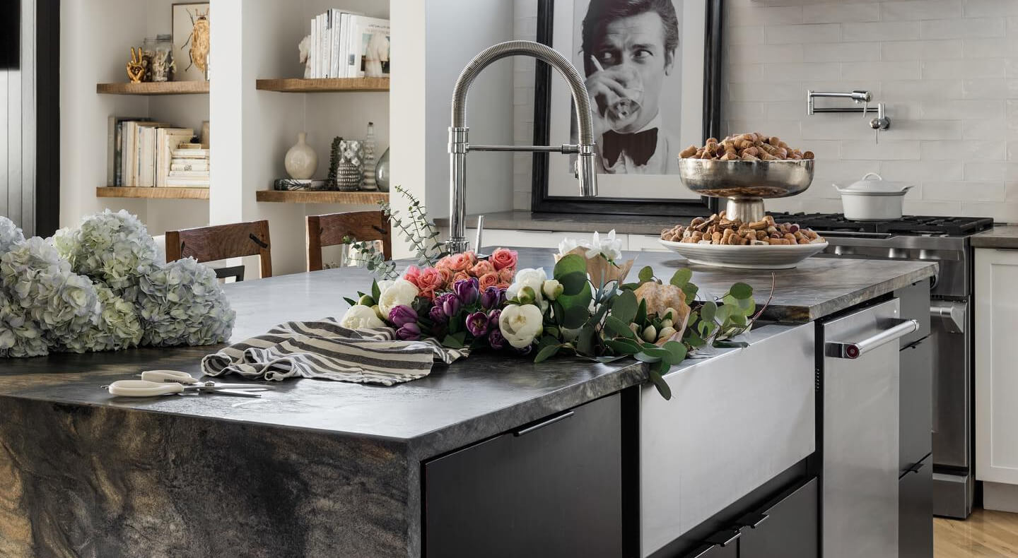 A kitchen island with a sink and dishwasher installed in it