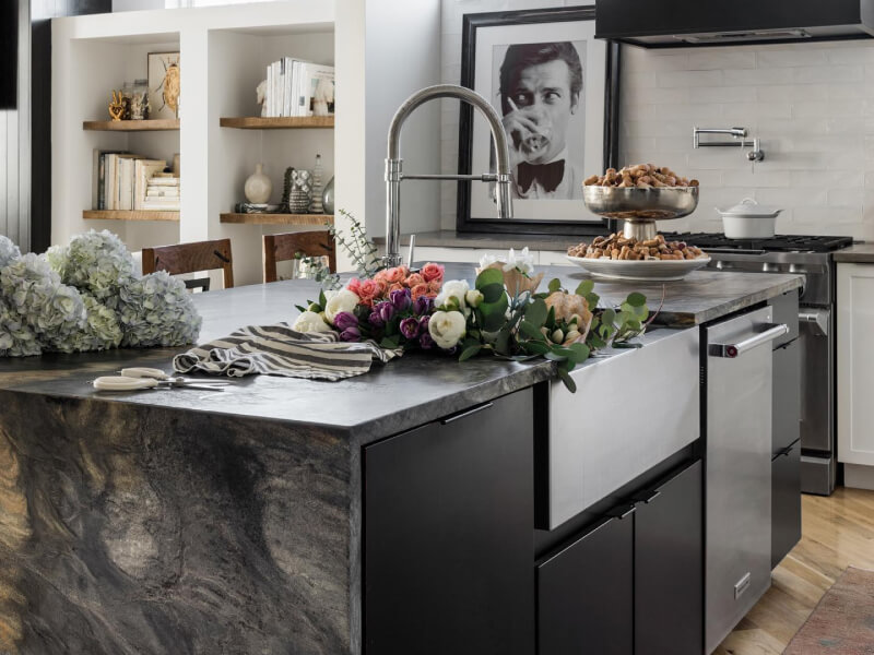 A kitchen island with a sink and dishwasher installed in it