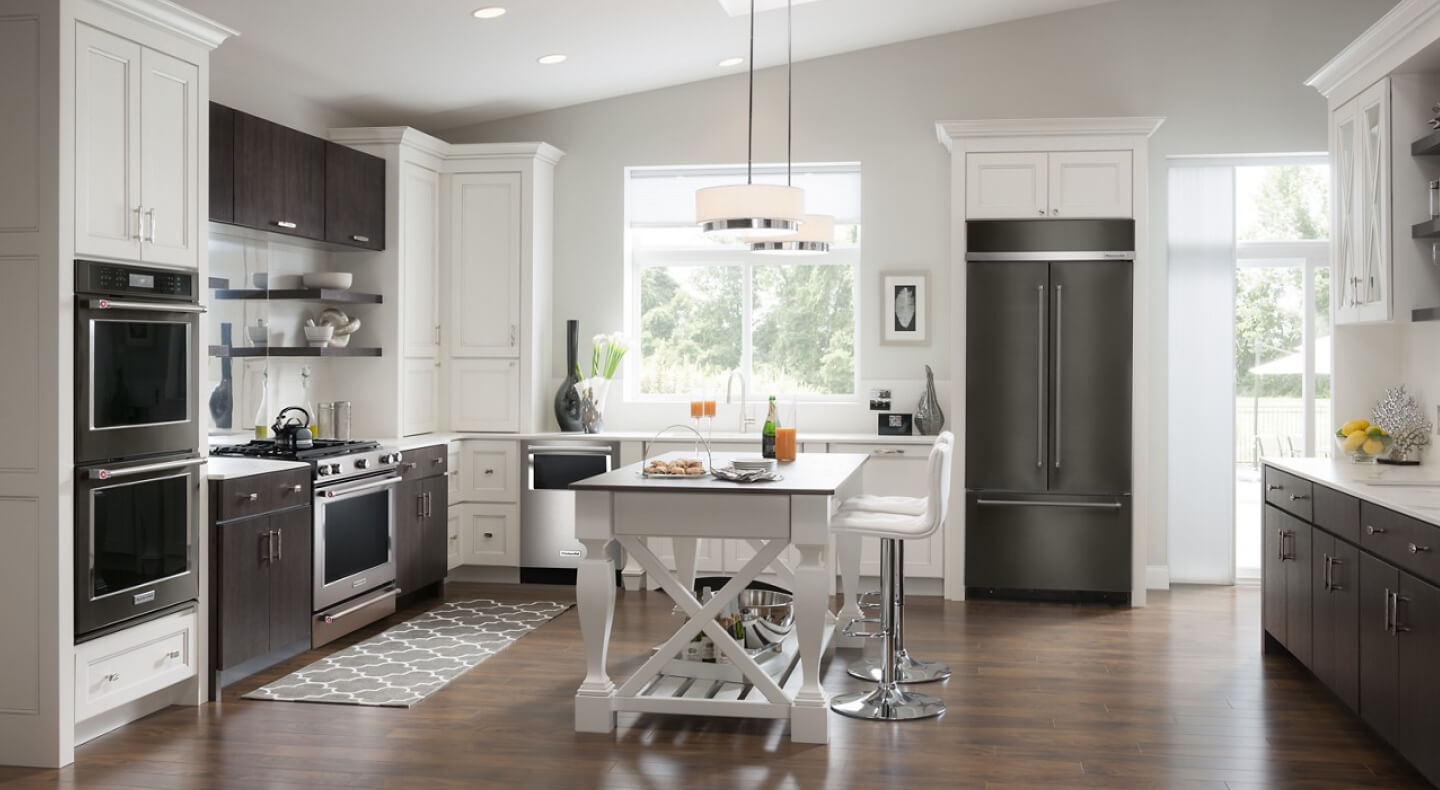 A kitchen with an island table and stool seating