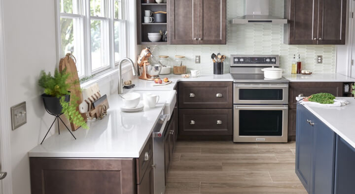A kitchen with stainless steel appliances and white countertops
