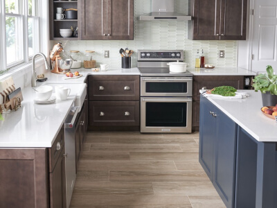 A kitchen with stainless steel appliances and white countertops