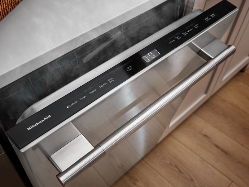 Dishwasher slightly open with steam coming out