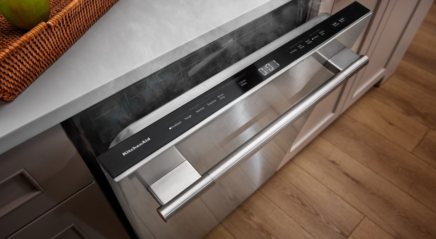 Dishwasher slightly open with steam coming out