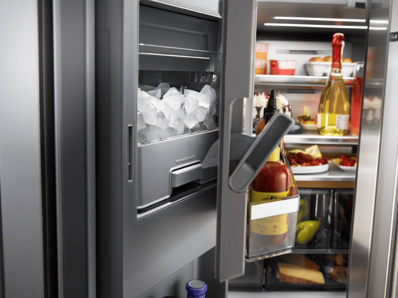 An in-door ice dispenser in a refrigerator