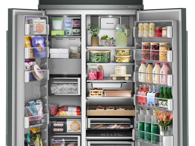 An open side-by-side refrigerator stocked with food