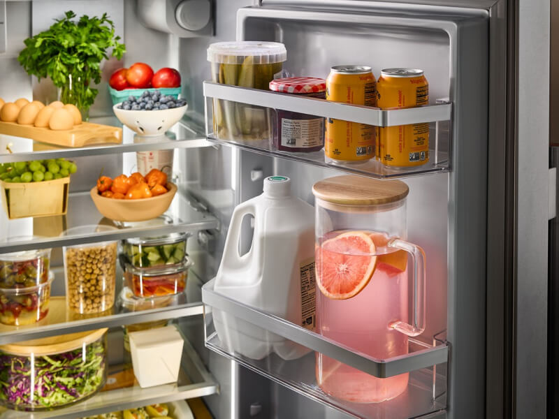 An open refrigerator with groceries inside