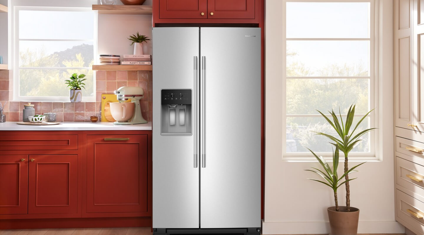 A side-by-side refrigerator with ice and water dispenser in a bright modern kitchen