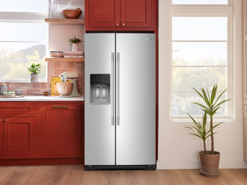 A side-by-side refrigerator with ice and water dispenser in a bright modern kitchen