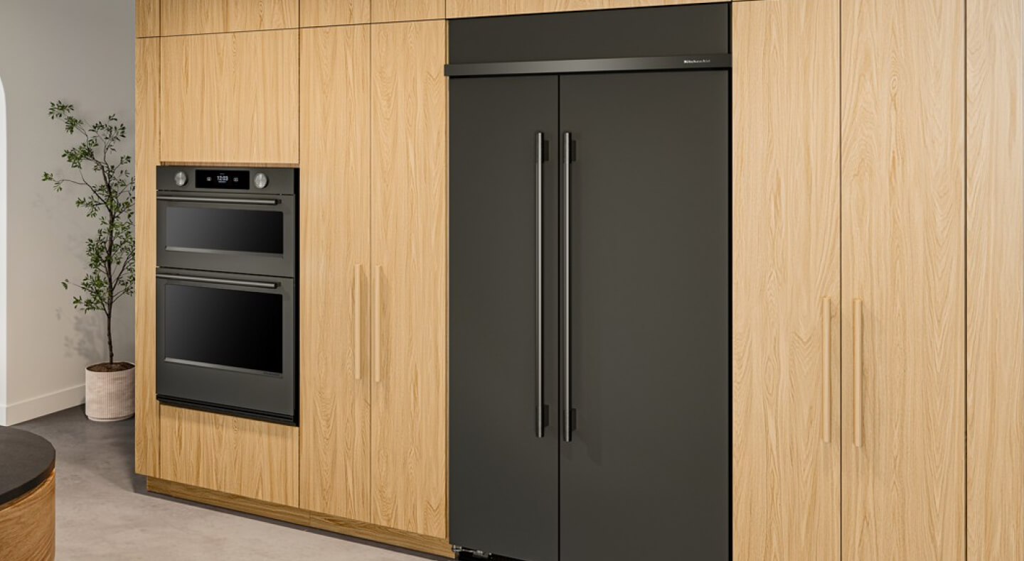 A built-in side-by-side refrigerator surrounded by modern wooden cabinetry