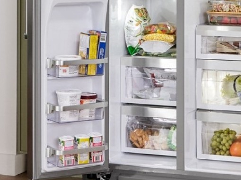 A refrigerator with an open freezer door