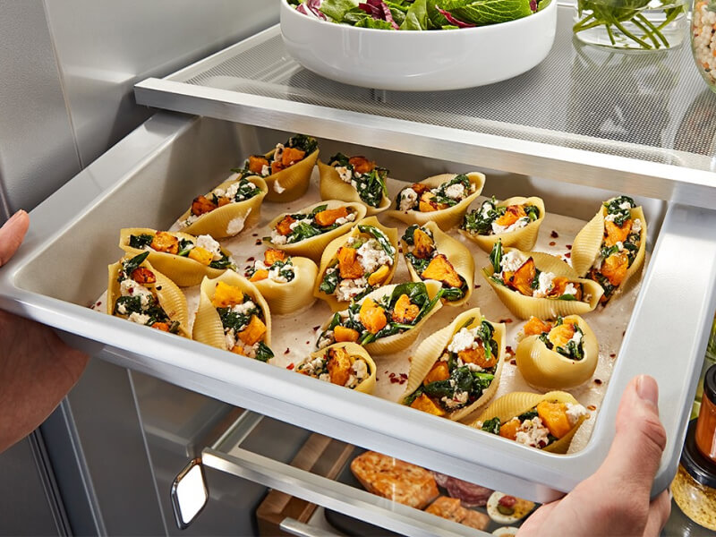 A refrigerator pull-out drawer with prepared food inside