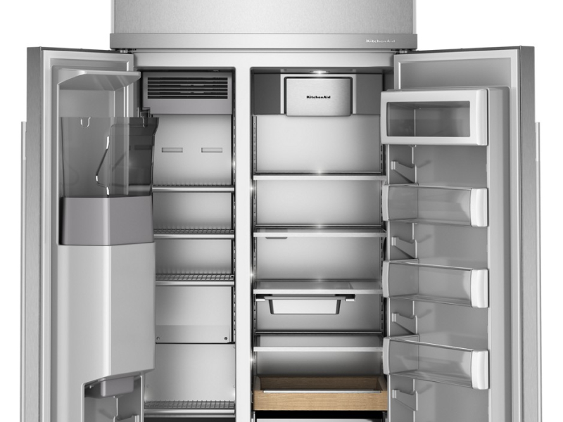 An open, empty, side-by-side refrigerator