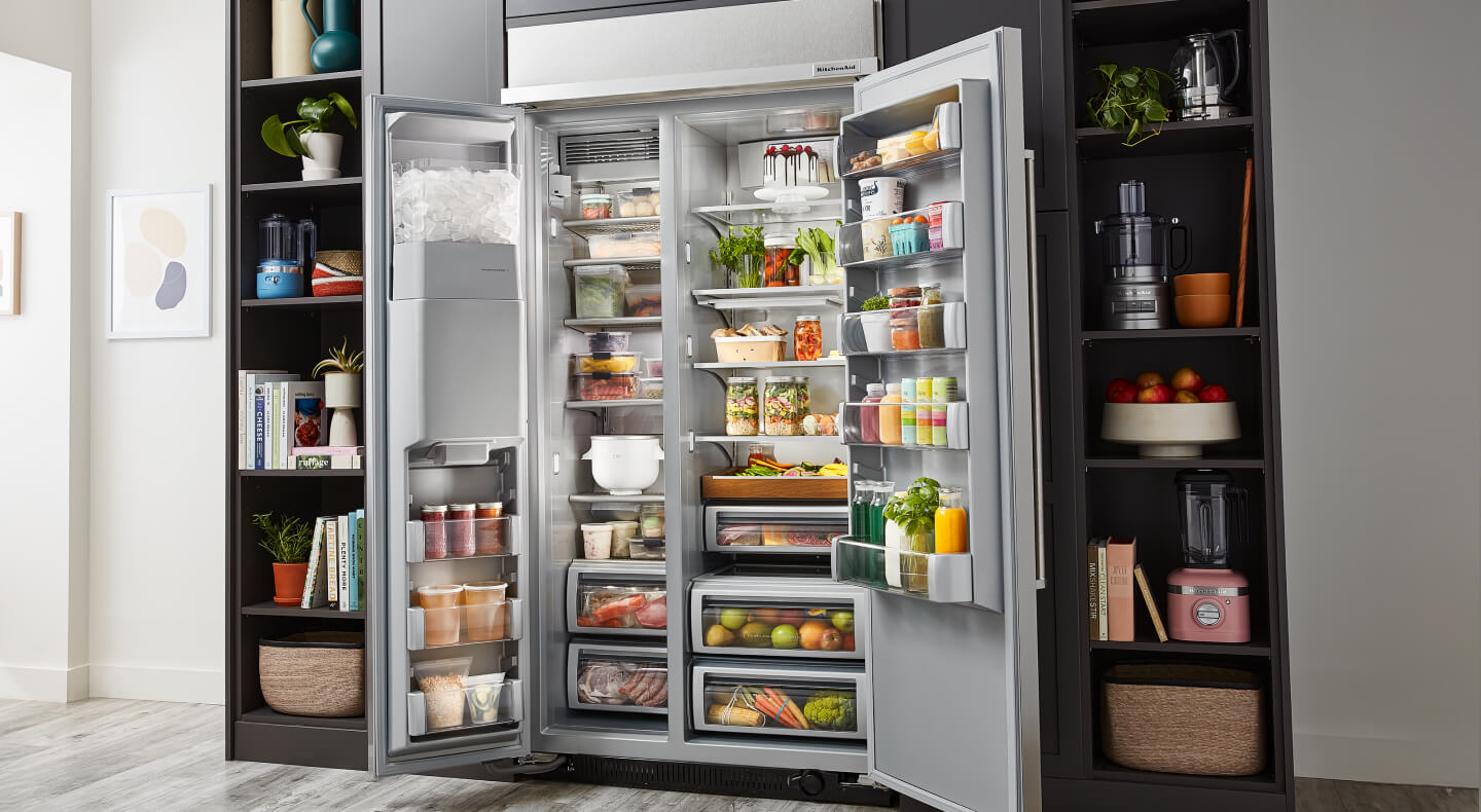 An open side-by-side refrigerator, full of colorful food items