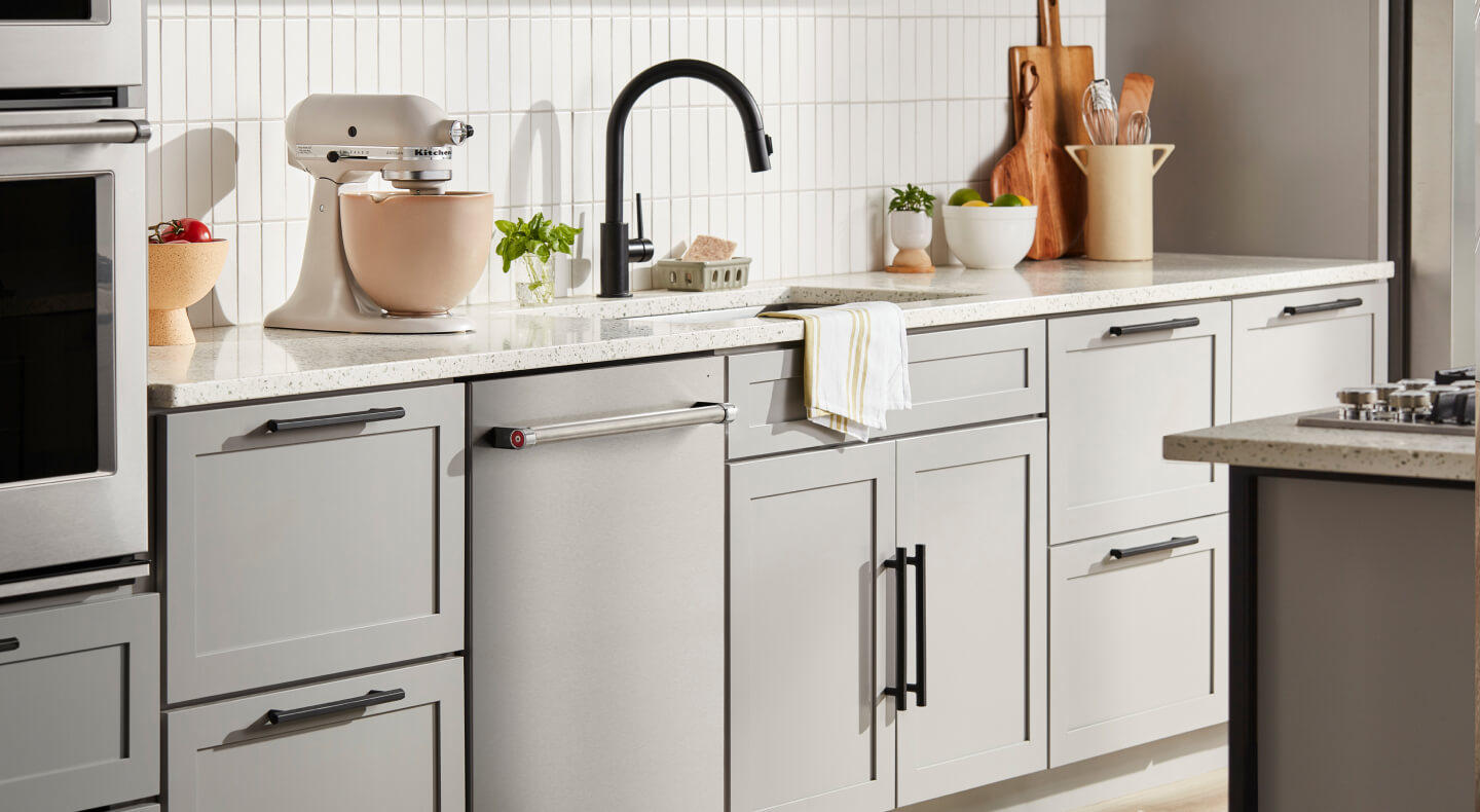 KitchenAid® flush dishwasher among light gray kitchen cabinetry