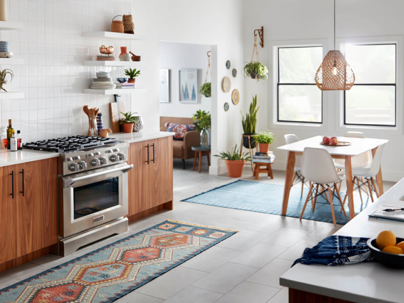 Open kitchen with a commercial-style gas range by KitchenAid brand