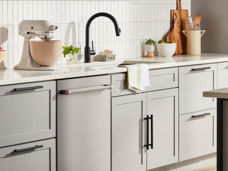 KitchenAid® flush dishwasher among light gray kitchen cabinetry