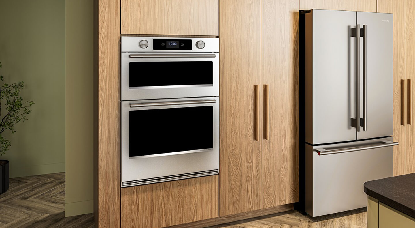 A KitchenAid® combination wall oven and refrigerator in a kitchen