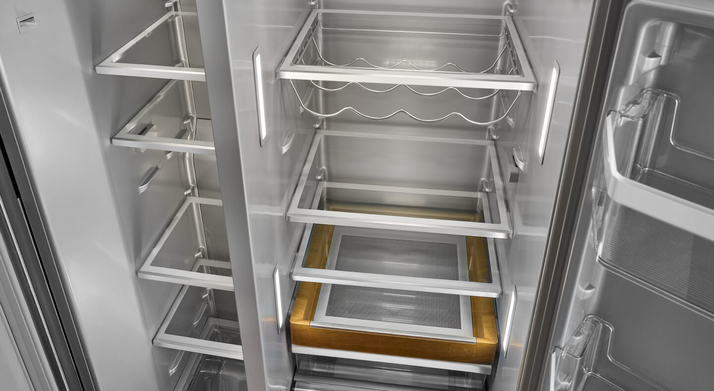 Empty KitchenAid® side-by-side refrigerator with a wine rack 