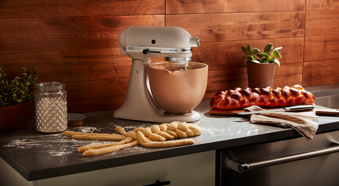 KitchenAid® stand mixer with freshly baked bread on the counter.