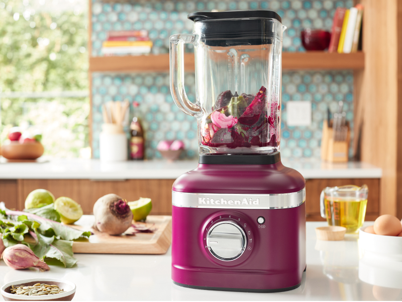 A KitchenAid® blender with fresh vegetables in a modern kitchen.