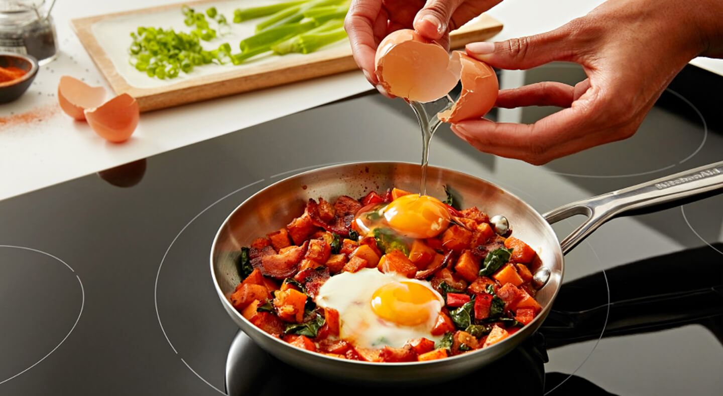 Person cooking on induction cooktop