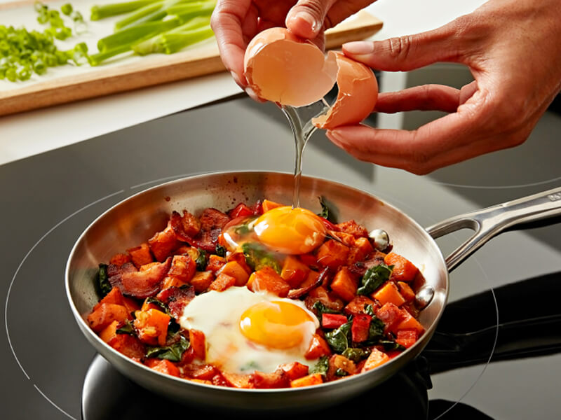 Person cooking on induction cooktop