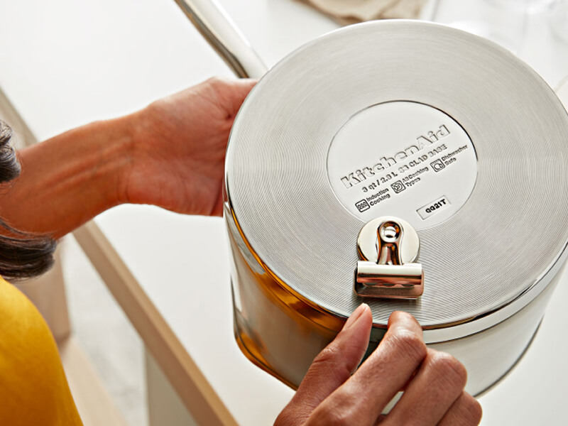 Person performing magnet test on KitchenAid® cookware