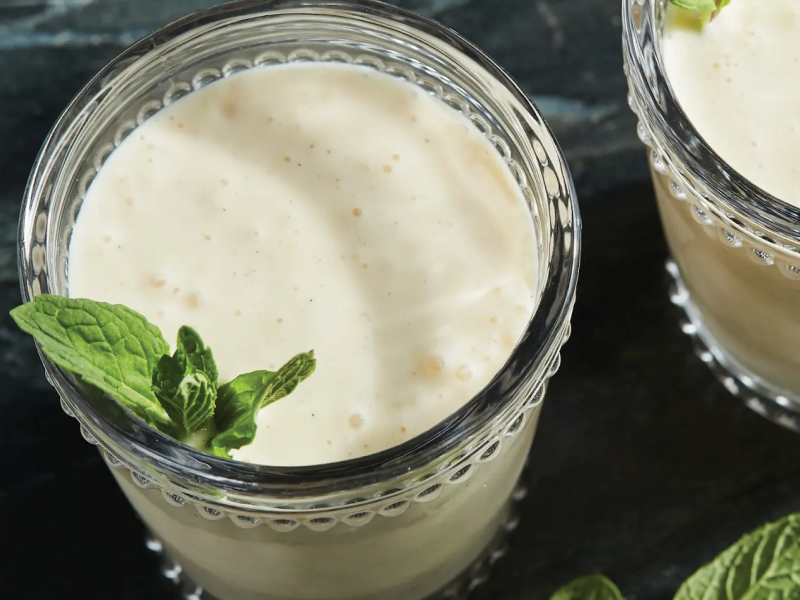 Close-up of white smoothie garnished with mint leaves