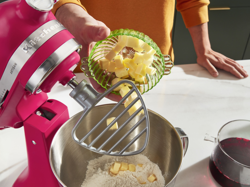Person adding butter into a KitchenAid® stand mixer