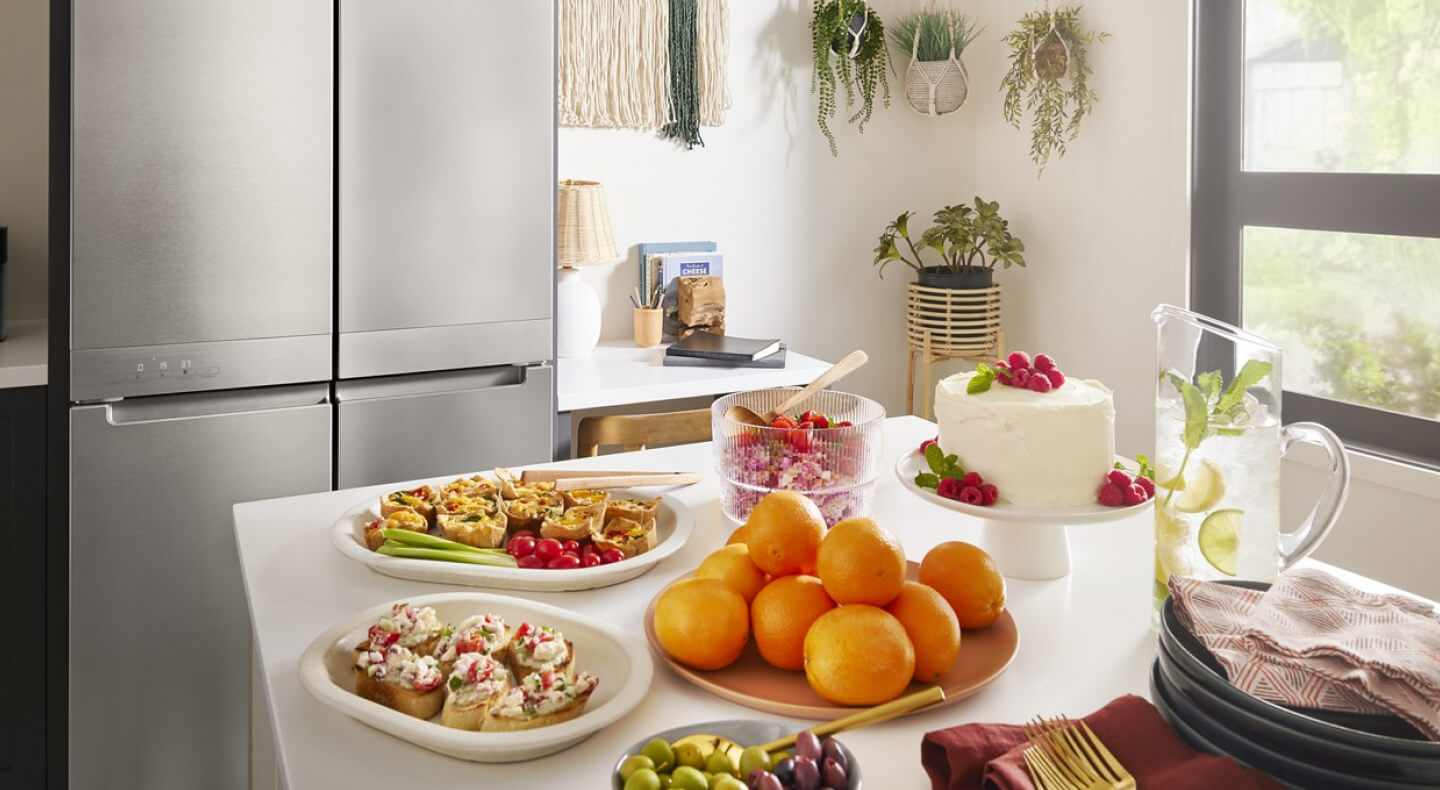 A kitchen with various bright, colorful food arranged on a counter