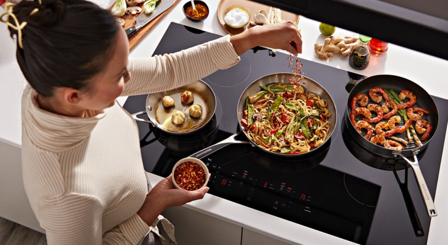 Person cooking on an electric cooktop