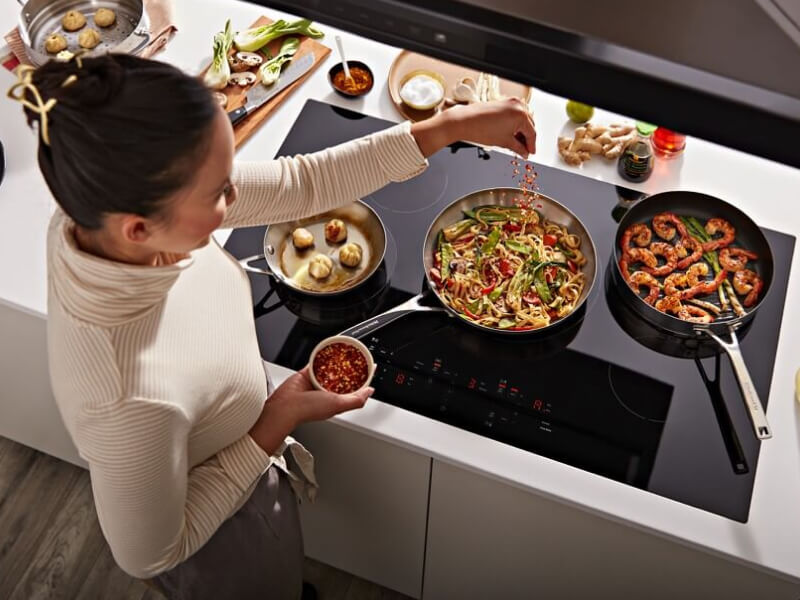 Person cooking on an electric cooktop